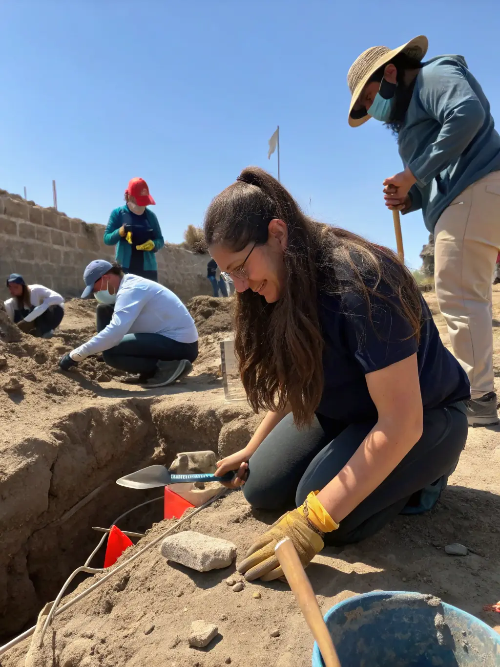 A photograph showcasing ASSA members collaborating with local authorities to implement a site protection plan, including fencing, signage, and monitoring systems, at a vulnerable archaeological site.